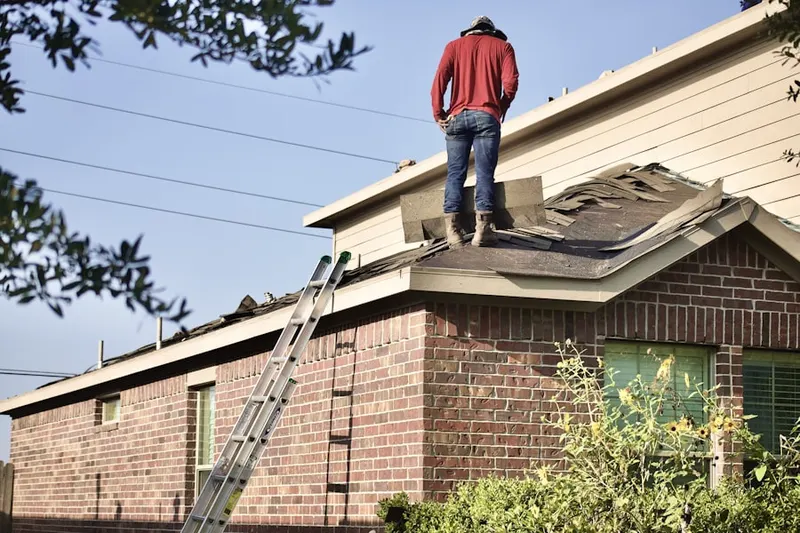 Professional roofer working on a residential roof in Minot